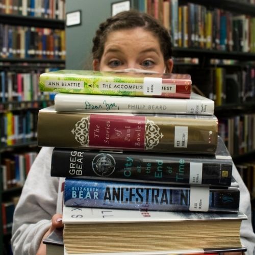 girl holding books